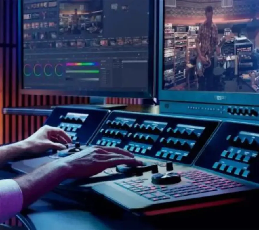 Audio Video System in Pakistan control room setup with a professional operator managing video editing panels and multiple screens for live production, powered by GreenTech Solution.