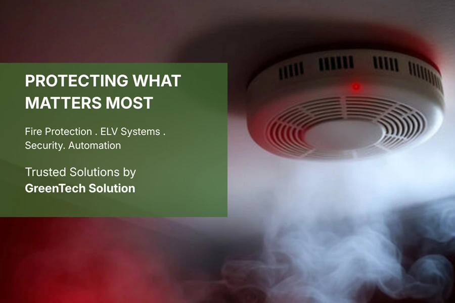 Smoke detector activating with rising smoke inside a building, representing fire protection and safety solutions provided by GreenTech Solution.